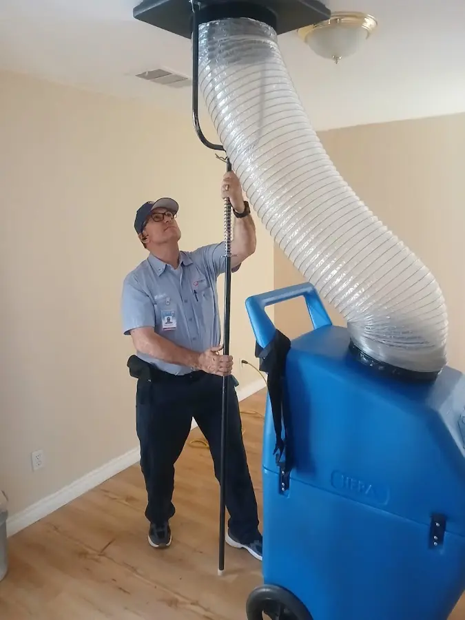 Furnace Tune-Up technician using HEPA equipment in Edgewater